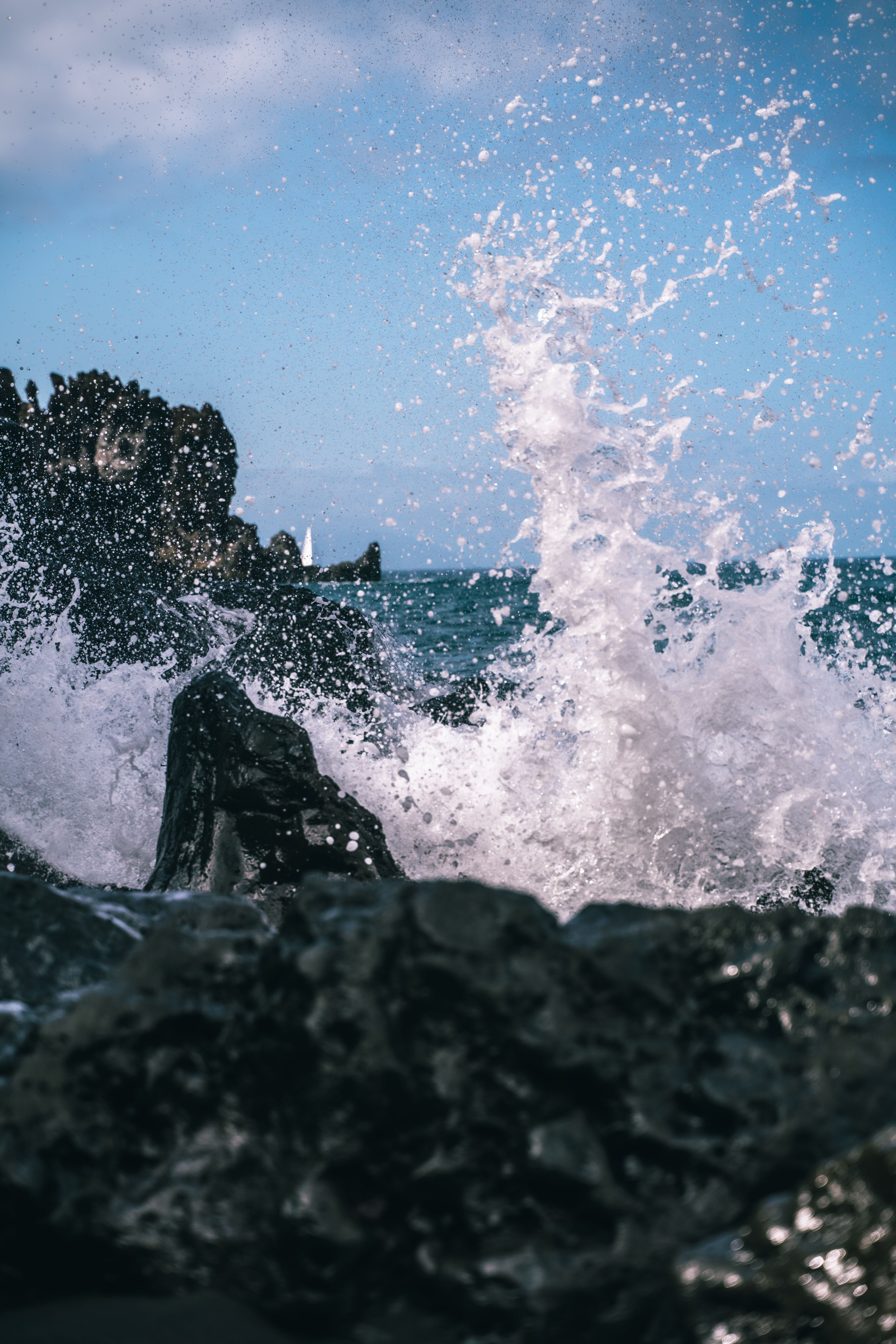 Whitewater bursting over rocks at a coastal entrance